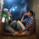 Palestinian tunnel workers smoke cigarettes as they rest inside a smuggling tunnel flooded by Egyptian security forces, beneath the Gaza-Egypt border in the southern Gaza Strip September 10, 2013. Egyptian security forces have stepped up a crackdown campaign on smuggling tunnels on the border between Egypt and Gaza Strip since last July, Hamas officials said.